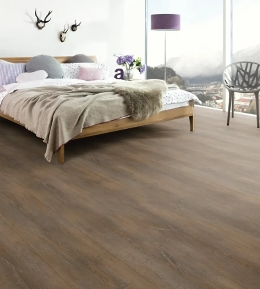 Bedroom with wood-effect flooring and natural light